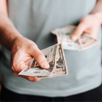 Man extending cash for payment