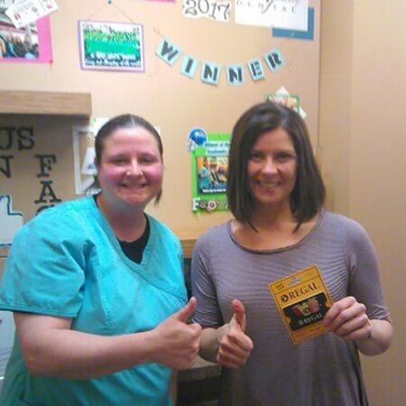 Patient and team member with Regal giftcard