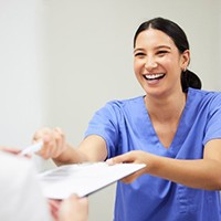 a front desk team member smiling at a patient