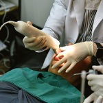 dentist working on patient under sedation