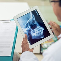 Dentist looking at skull x-ray