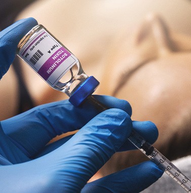 a needle drawing BOTOX out of a vial