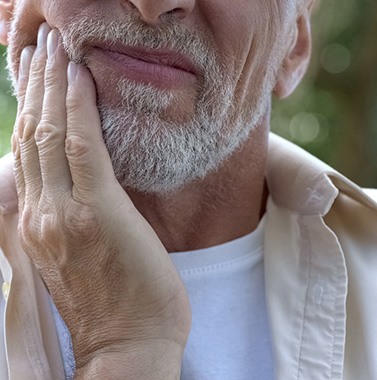 a man holding his jaw