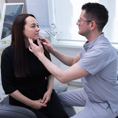 Dentist in Bellingham examining a patient's mouth during an oral cancer screening