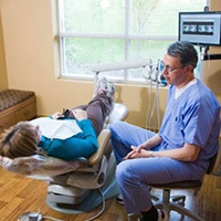 Dentist talking to patient in dental chair