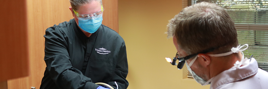 Dentist and assistant treating a patient