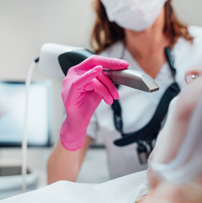 Dentist preparing to take digital scans of a patient's teeth