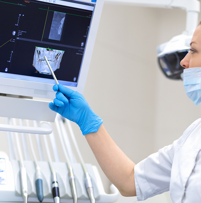 Dentist showing a patient an x-ray of their teeth