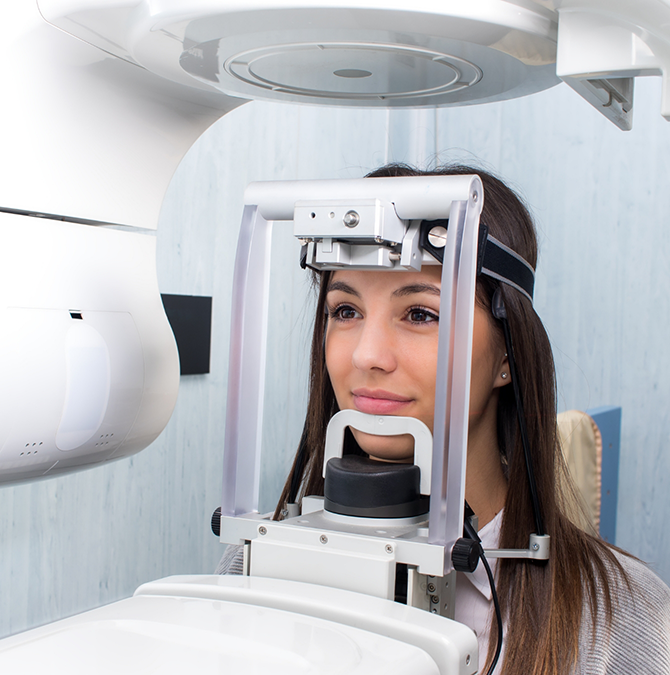 Dental patient getting a cone beam CT scan of her mouth and jaws
