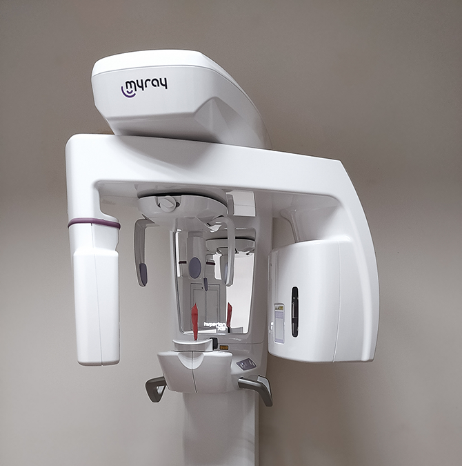 Cone beam CT scanner standing against a wall