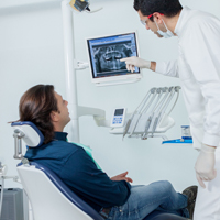 Dentist and patient looking at x-rays