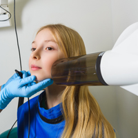 Young girl receiving traditional digital x-ray