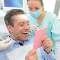 man smiling after getting dental bridge in Bellingham 