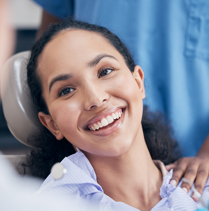 Young woman grinning at her dentist