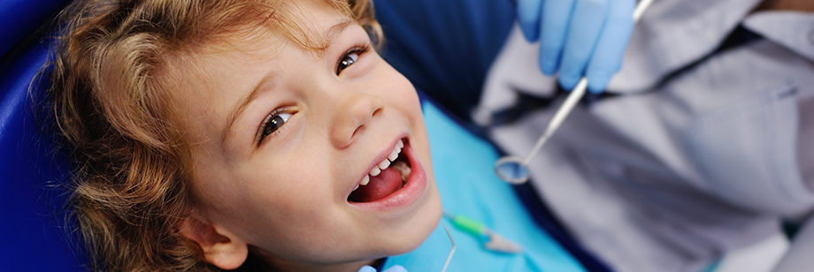 Young child smiling during a dental checkup