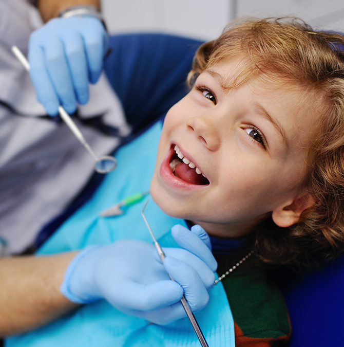 Young child grinning during a dental checkup