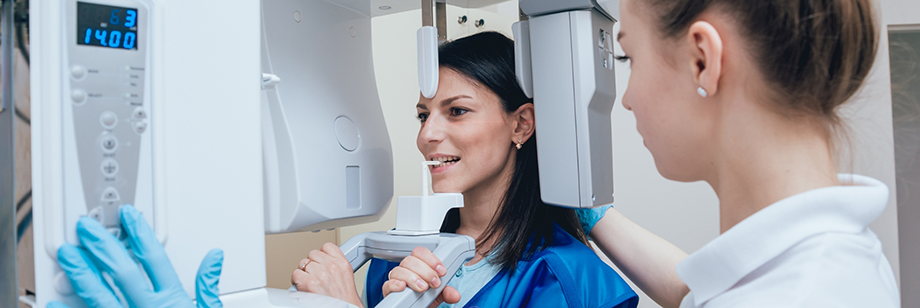 Dental patient getting a CT cone beam scan of her jaws and mouth