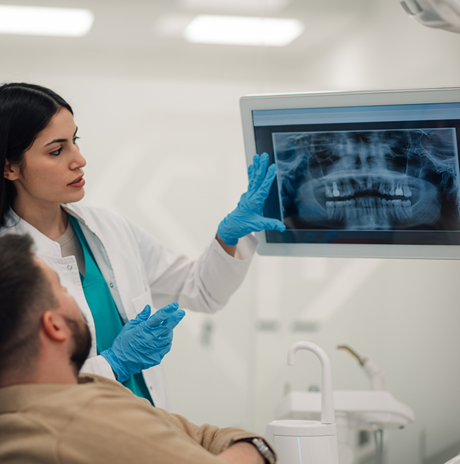 Dentist showing a patient their dental x-rays