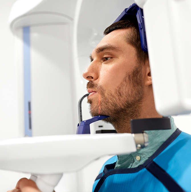 Man getting a CT cone beam scan of his mouth and jaws