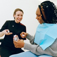 Woman speaking with dentist about dental crowns