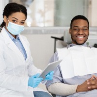 patient smiling after getting a dental crown in Bellingham 