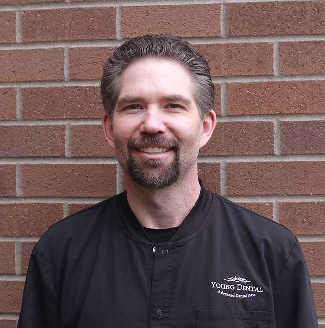 Smiling Young Dental team member in black scrubs