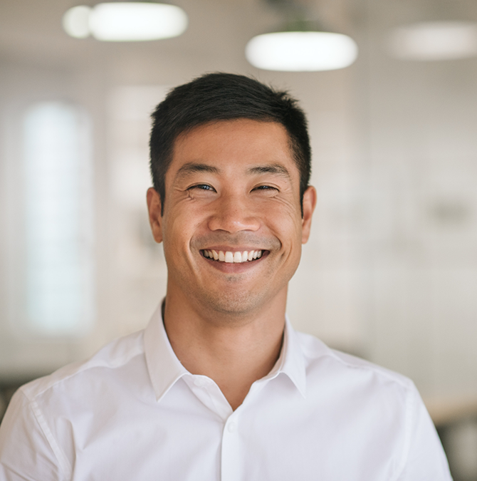 Smiling man in a white collared shirt