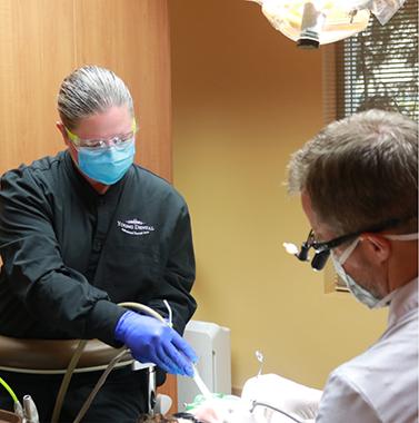 Dentist and assistant treating a patient
