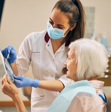 Dentist showing a senior patient an x-ray of their teeth