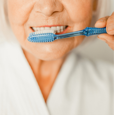 Senior woman brushing her teeth