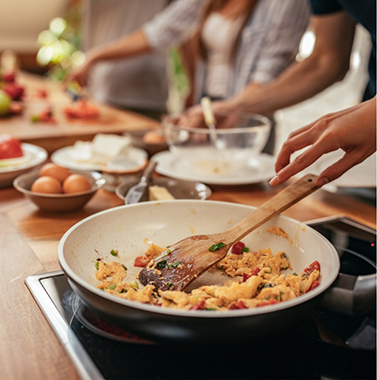Person cooking vegetables