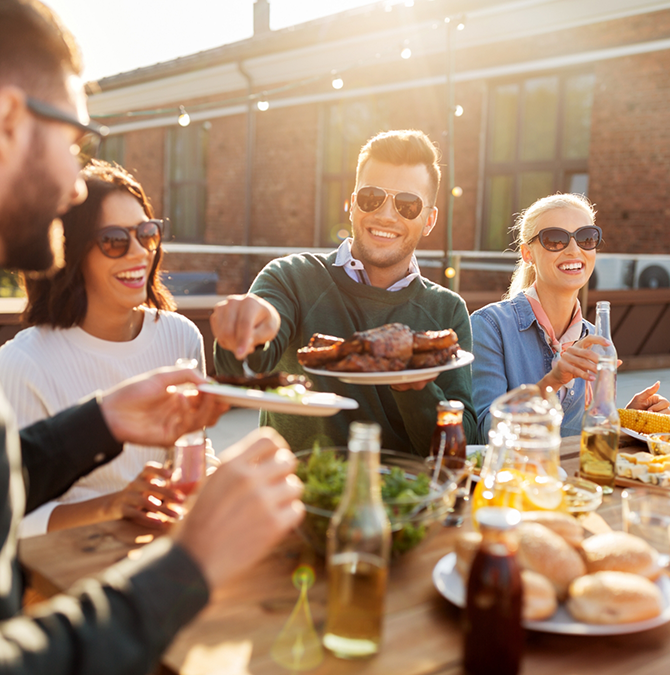Group of adults enjoying dinner outdoors