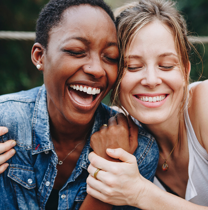 Two women laughing together