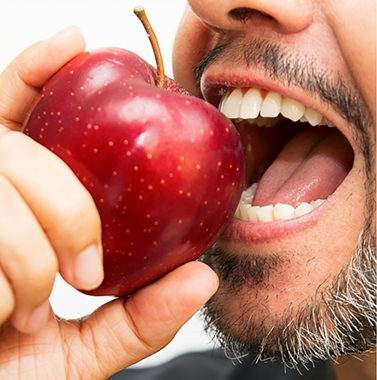 Man biting into a red apple