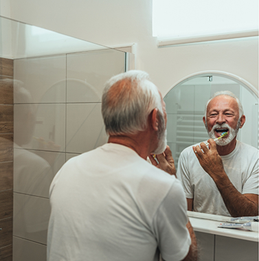 Senior man brushing his teeth