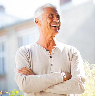 Smiling older man in a white long-sleeved shirt