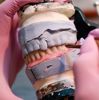 Dentures being adjusted in a dental lab