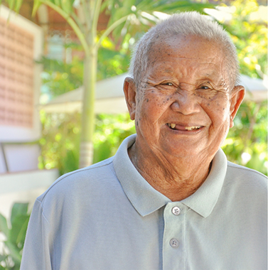 Senior man smiling with several upper teeth missing