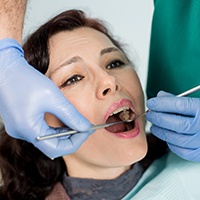 a person receiving an emergency dental examination