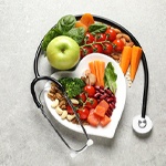 healthy foods arranged on a heart-shaped plate with a stethoscope around it