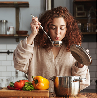 Woman cooking vegetables at home