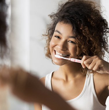 Young woman brushing her teeth