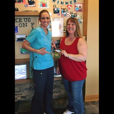 Smiling female patient with giftcard