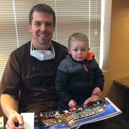 Dr. Young and child reading a book