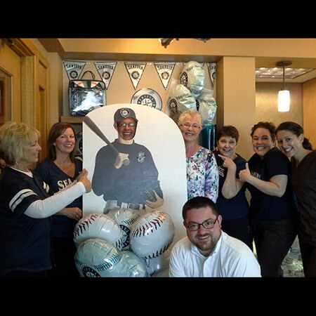 Team posing with Mariners