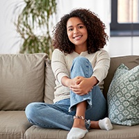 a person relaxing on a couch and smiling