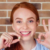 Woman smiling after tooth extraction in Bellingham