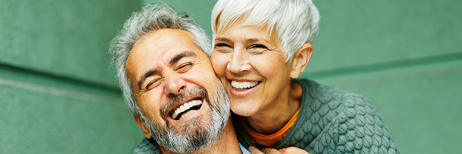 Happy senior couple embracing after a full mouth reconstruction in Bellingham