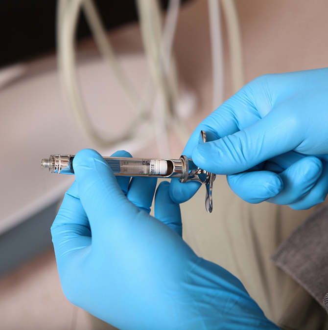 Dentist preparing a syringe