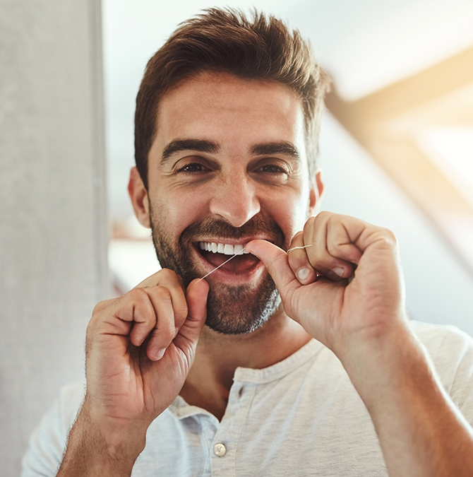 Man flossing his teeth